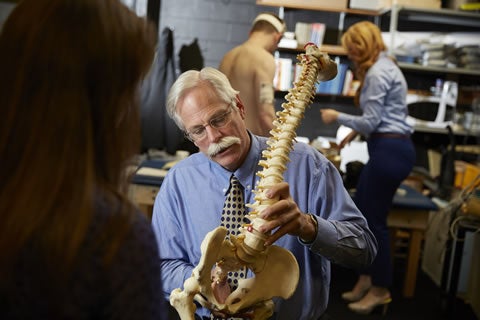 Professor Stuart McGill uses spine model to demonstrate herniation.