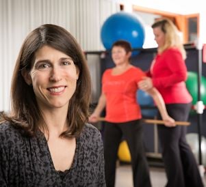 Lora Giangregorio in foreground with female teaching another female exercises in background