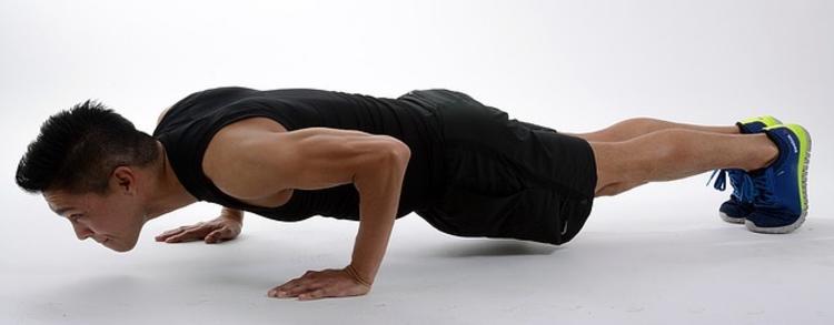 Photo of person doing a pushup.