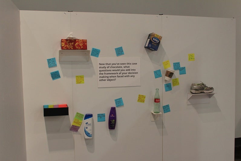 Exhibit wall suggesting that consumers investigate before buying popular products.