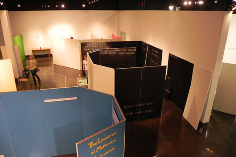 Overhead view of blue and black walls being constructed in the gallery.