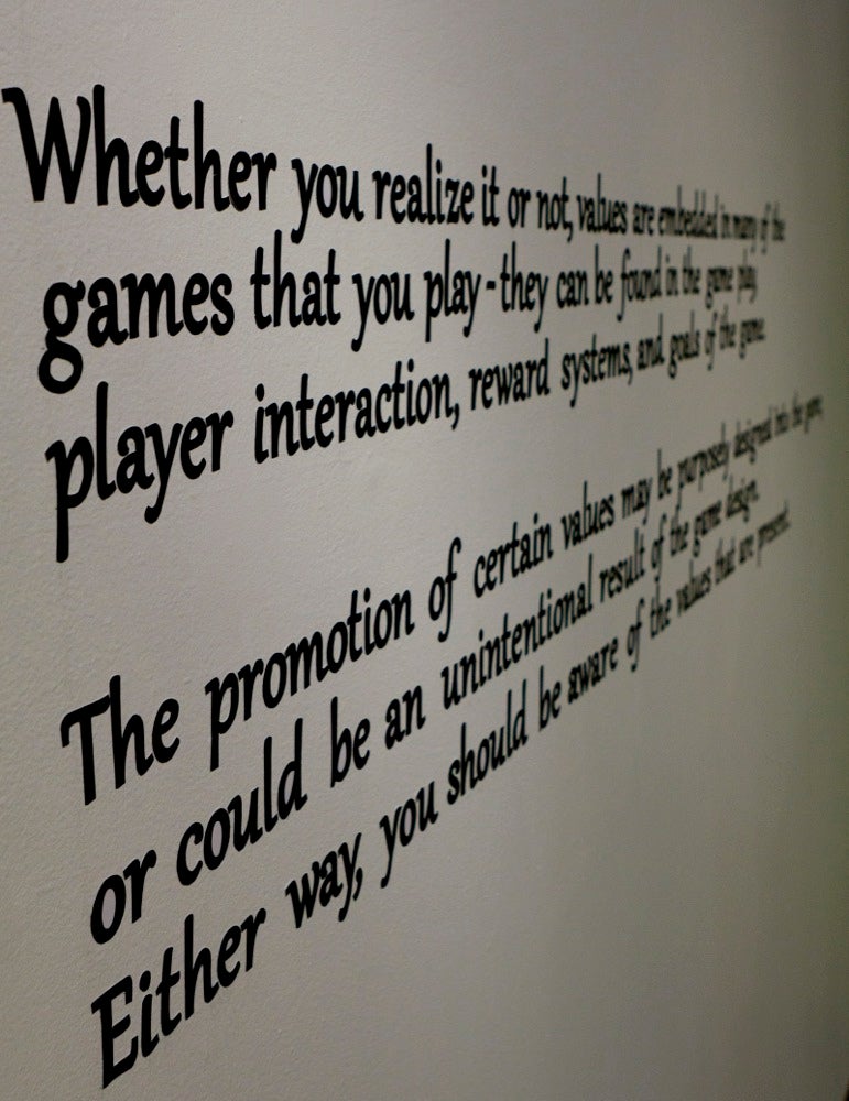 Exhibit wall explaining effect of board games.