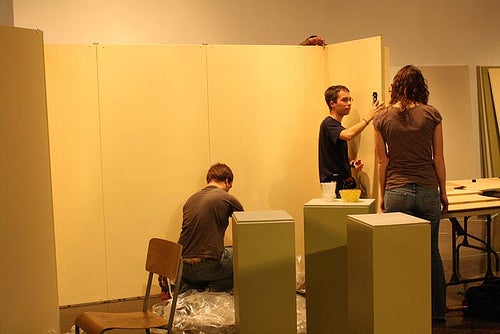 Three students setting up "Guess What?" exhibit.