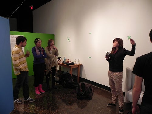 Vanessa explaining her point of view to three other students in gallery.