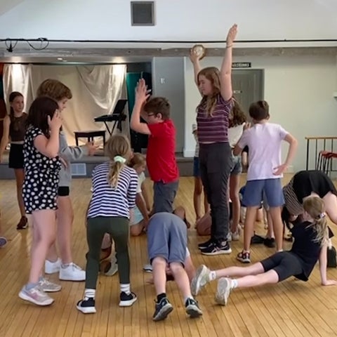 Sylvie working with kids on a play
