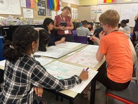 Emma overseeing students' work