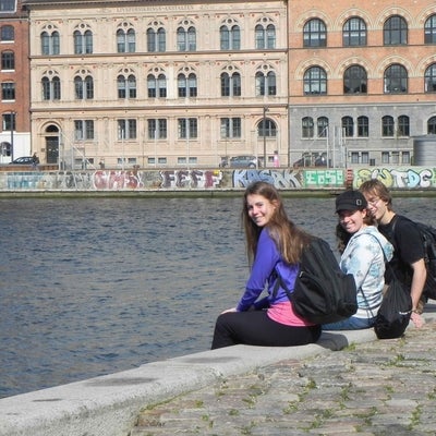 Students sitting on canal wall