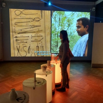 Student picking up exhibit items