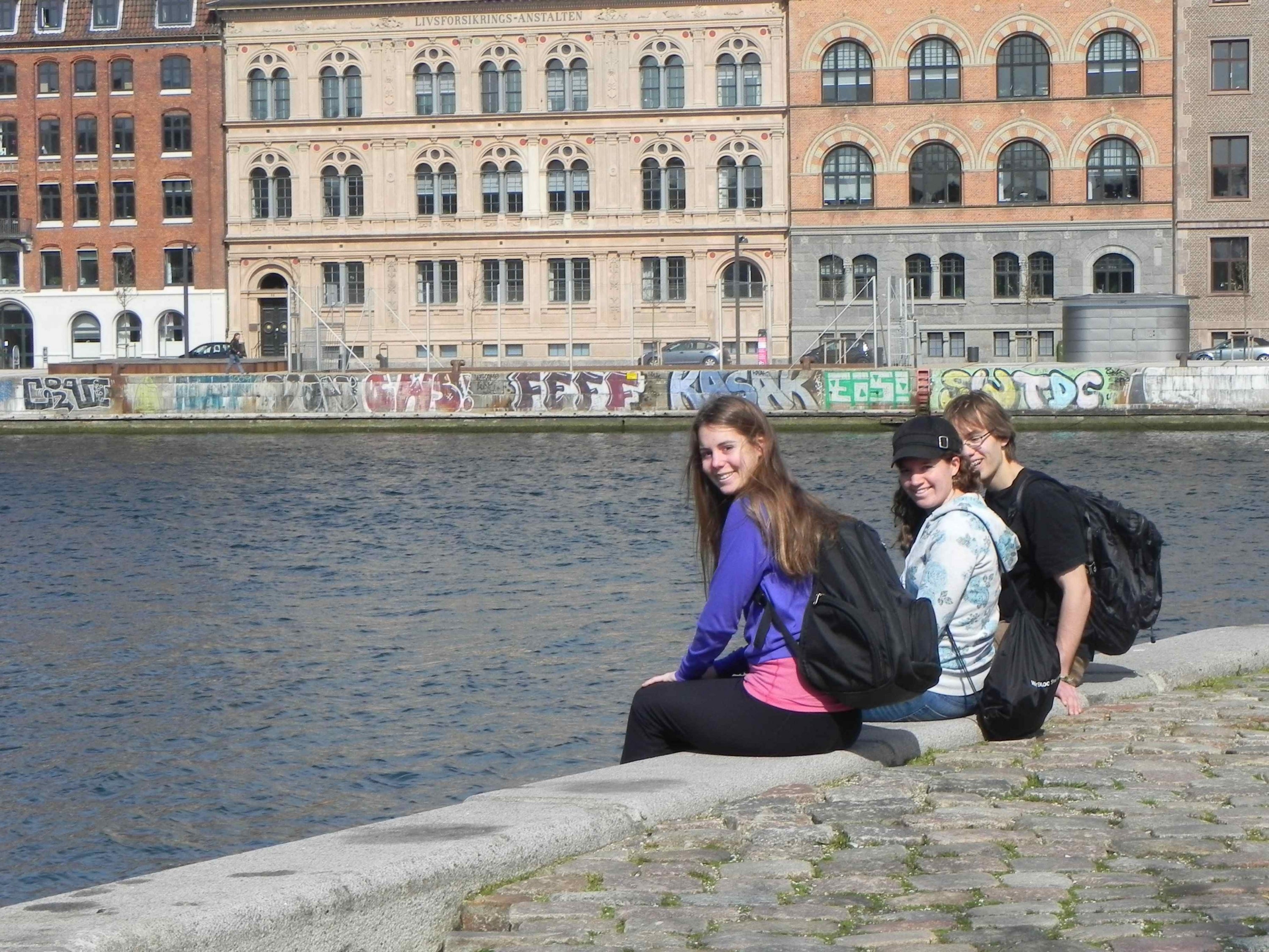 Students sitting on canal wall