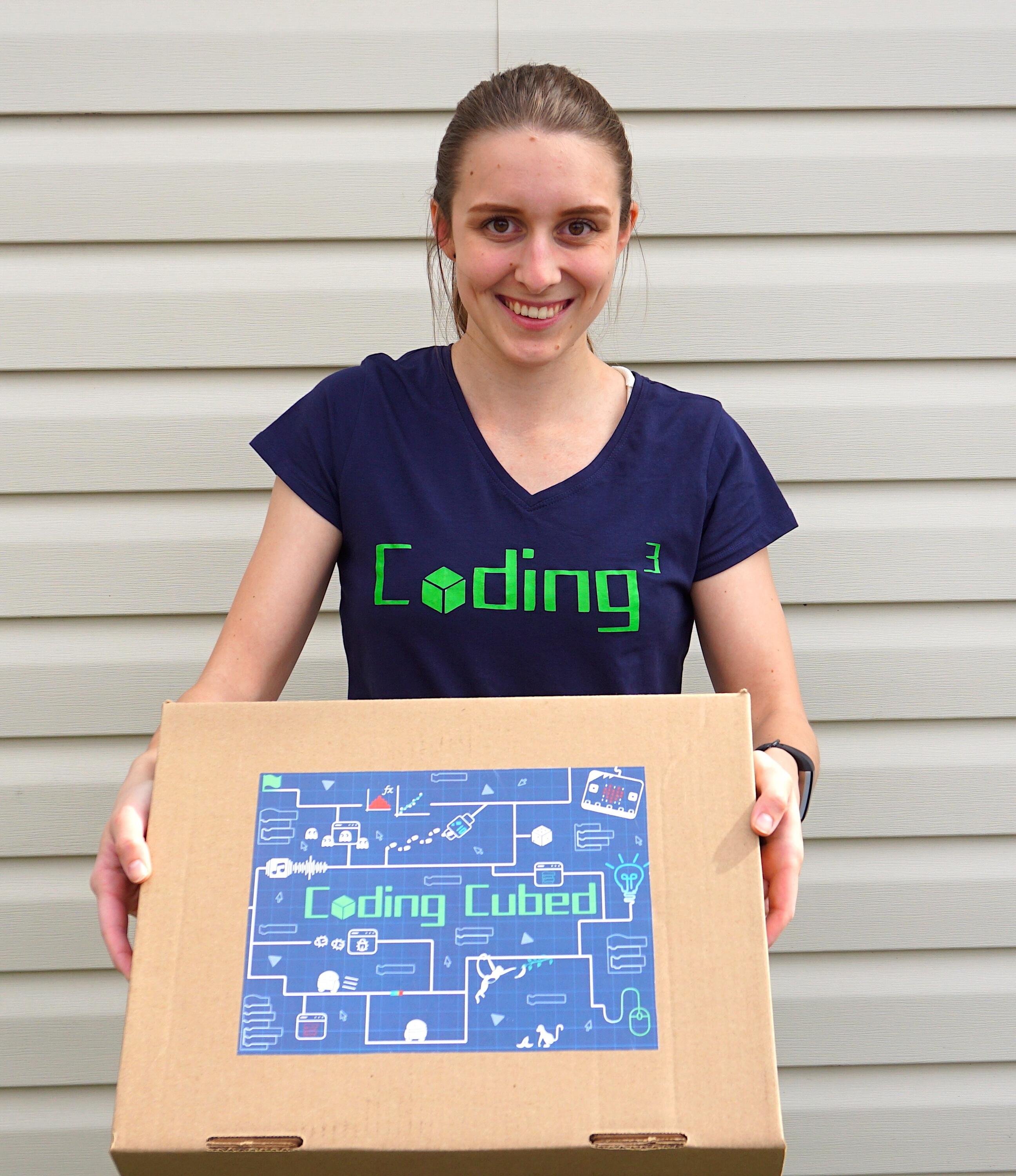 Cassidy holding the coding curriculum kit