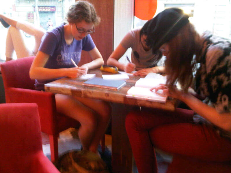 Students writing postcards