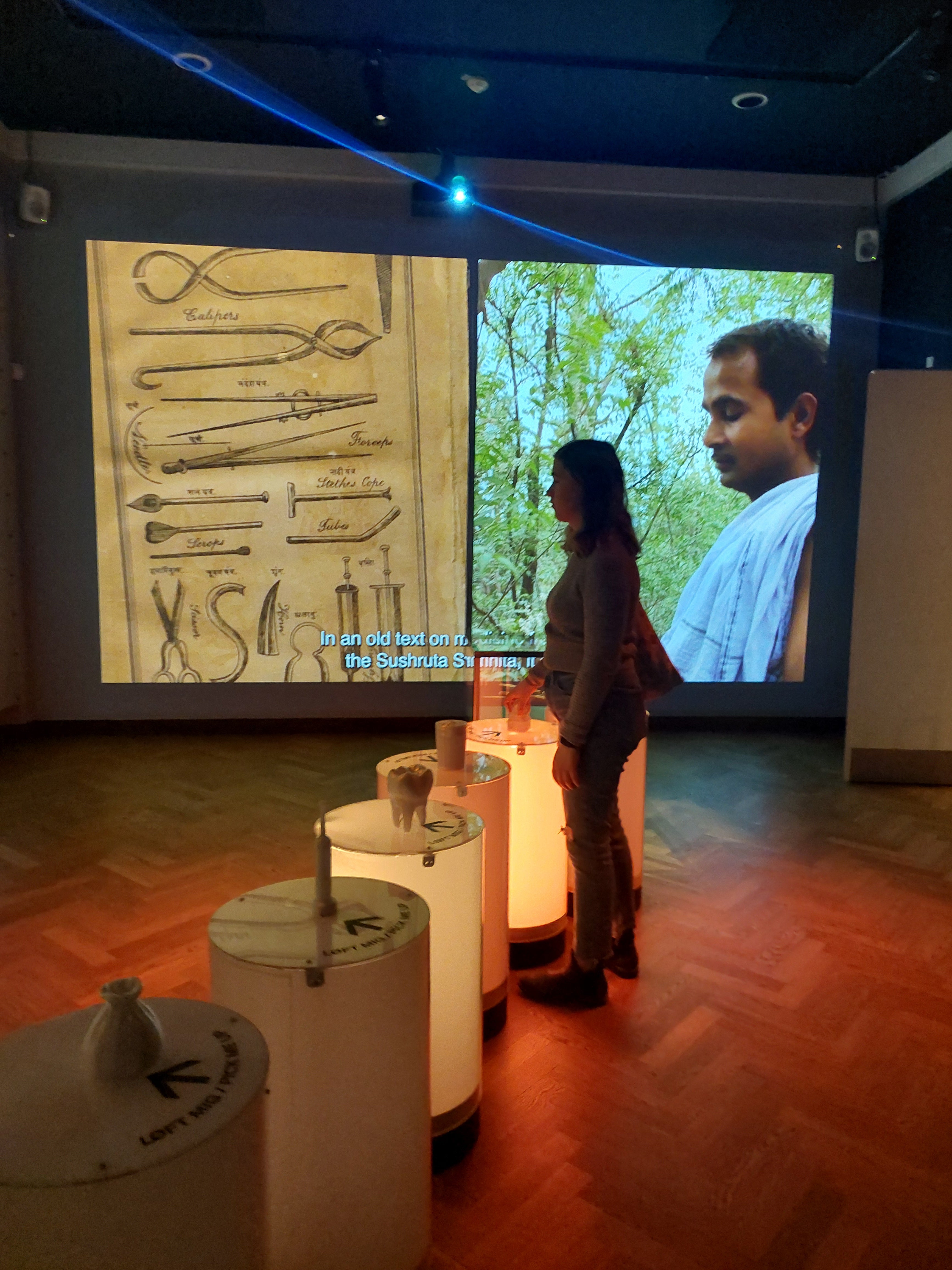 Student picking up exhibit items