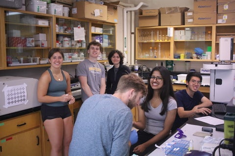 Wideshot Photo of finger tip prick with a group of teens