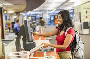 A student using the self-check machine
