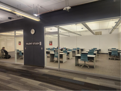 Glass-walled silent study room with individual desks, teal chairs, and a visible “Silent Study” sign outside.