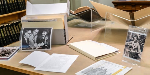 Archival records, photographs, books, and documents from University of Waterloo Libraries Special Collections & Archives displayed on a table. 