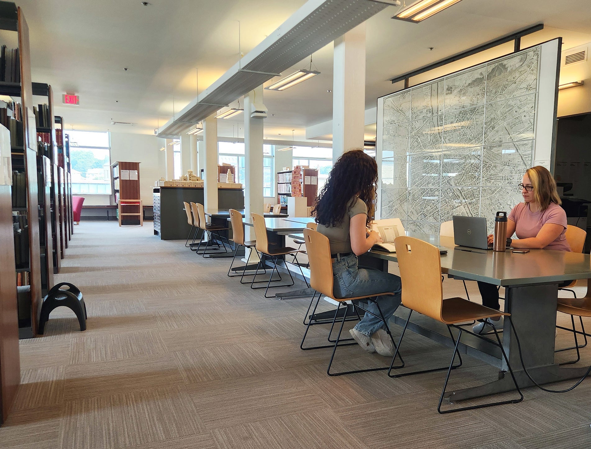 two women are seated at a study table in Musagetes Library