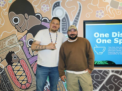 Kevin George, associate director, Indigenous initiatives at the Libraries, and Tsista Kennedy, mural artist