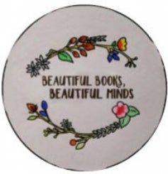 A button design with the words &quot;beautiful books, beautiful minds&quot; surrounded by a floral design.