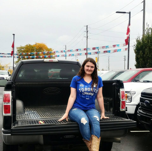 Shannon sitting on the truck