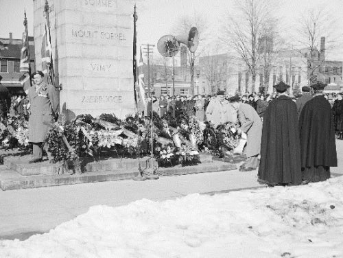 At the 1951 Remembrance Day ceremony, people lay wreaths at the cenotaph.