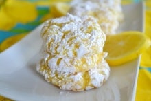 Lemon crinkle cookies on a white plate.