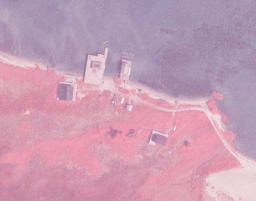 infrared image shows close-up view of lake erie shoreline,  showing buildings, roads and boats