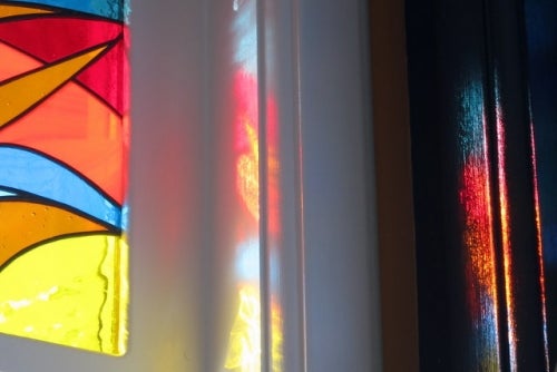 stained glass window reflecting light onto walls