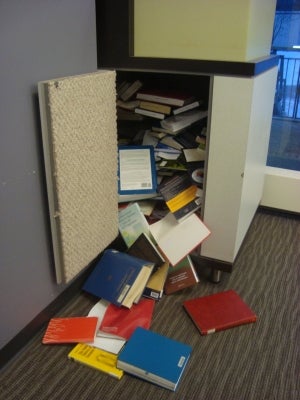 Books falling out of the book drop when opening it after the holidays