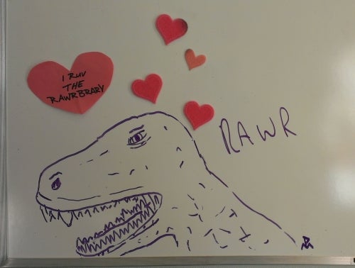 Hand drawn dinosaur with red hearts
