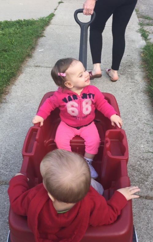 smiling baby in a wagon