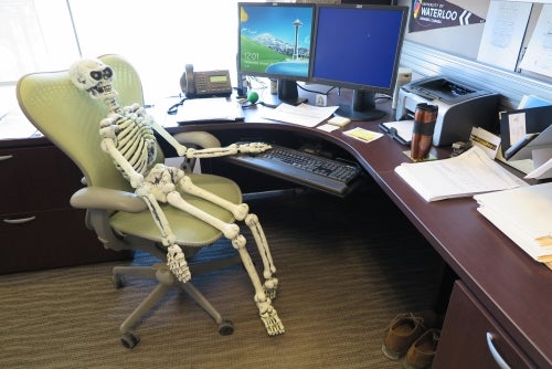 Skeleton in front of desk