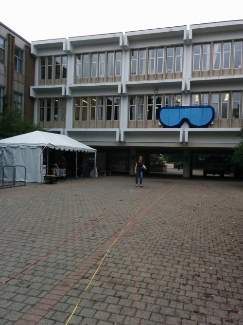 Giant glasses hanging from a campus building during frosh week