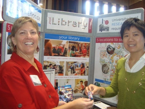 Sharon Lamont with a student at one of the LIbrary displays.