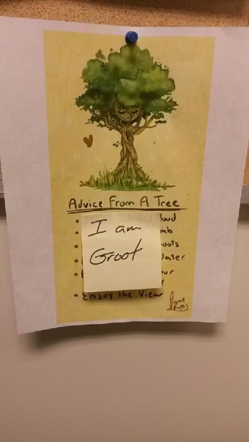 A post it note stuck to a poster reading &quot;I Am Groot&quot;.
