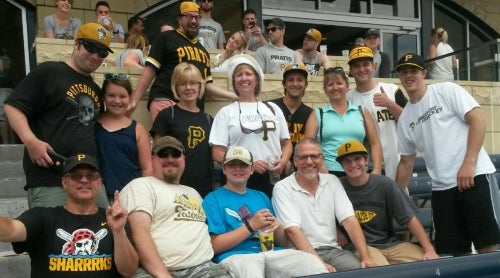 Sharon Lamont's family in the stands at a baseball game.