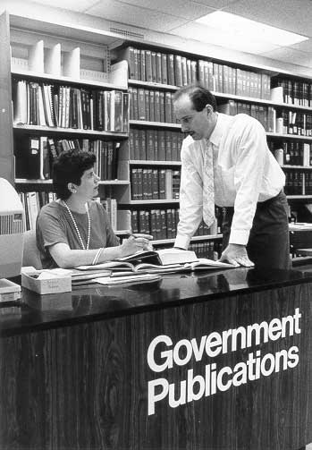 Staff helping a patron at the Government Publications Desk.