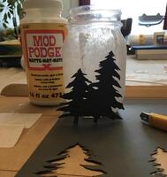 mason jar with two trees cut out