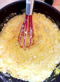 yellow ingredients in bowl with whisk
