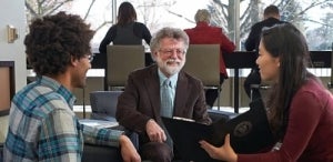 Mark Haslett chatting with students in Dana Porter Library.