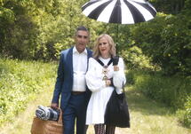 man and woman walking with umbrella