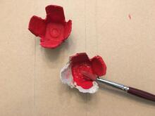 red painted egg carton poppy flower