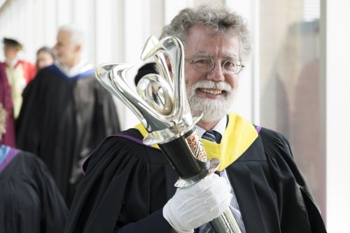 Mark Haslett carries the University's mace during last June's convocation ceremony.
