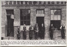 Black and white photograph of seven men standing in front of the Berliner Journal building, with caption.