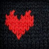 red heart knit into black sweater