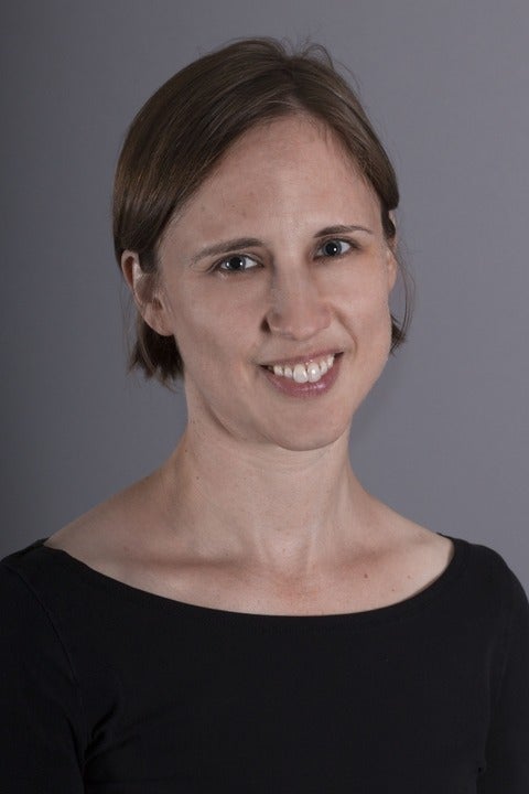 A woman with a black shirt smiling at the camera