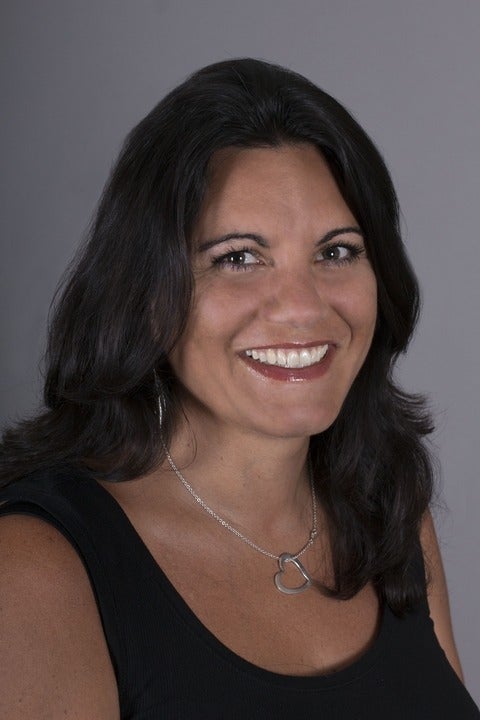 Woman in a black shirt smiling at the camera