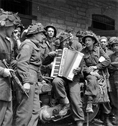 Soldiers listening to an accordian player