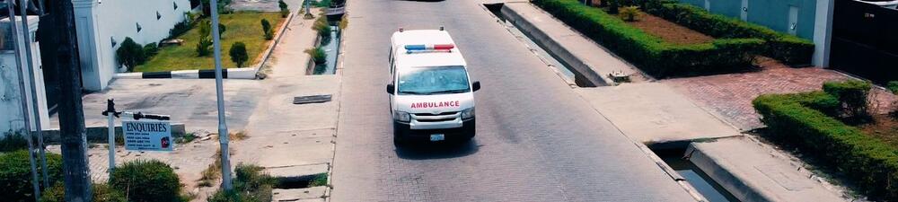 Ambulance driving down a road
