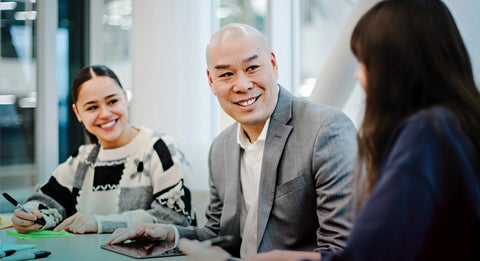 Simon Chan sitting down to talk to two people